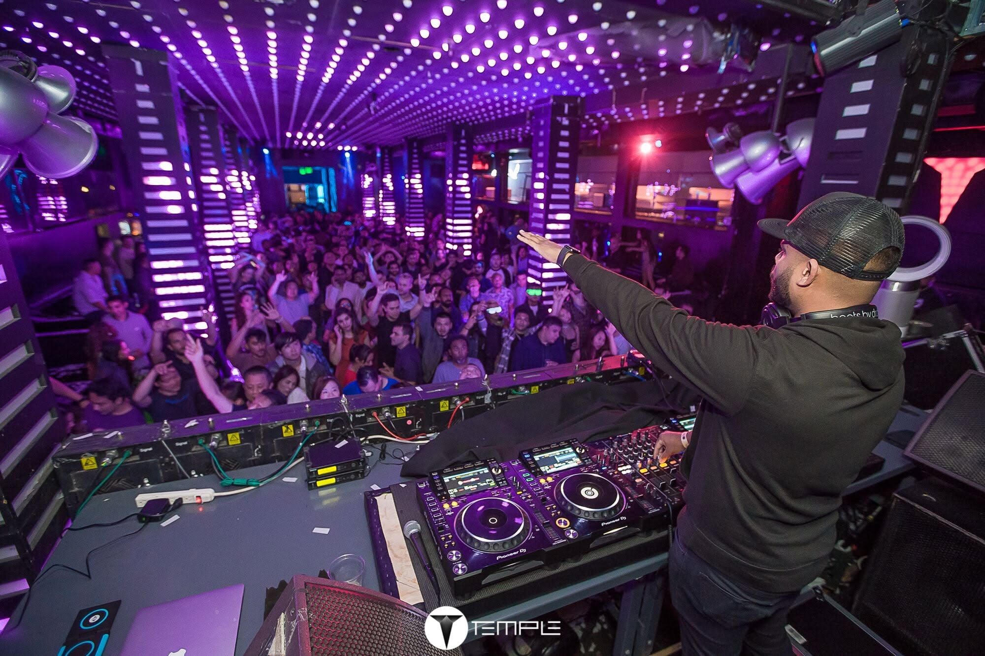 Sony Jacob connecting with a full dance floor at Temple beneath purple lights
